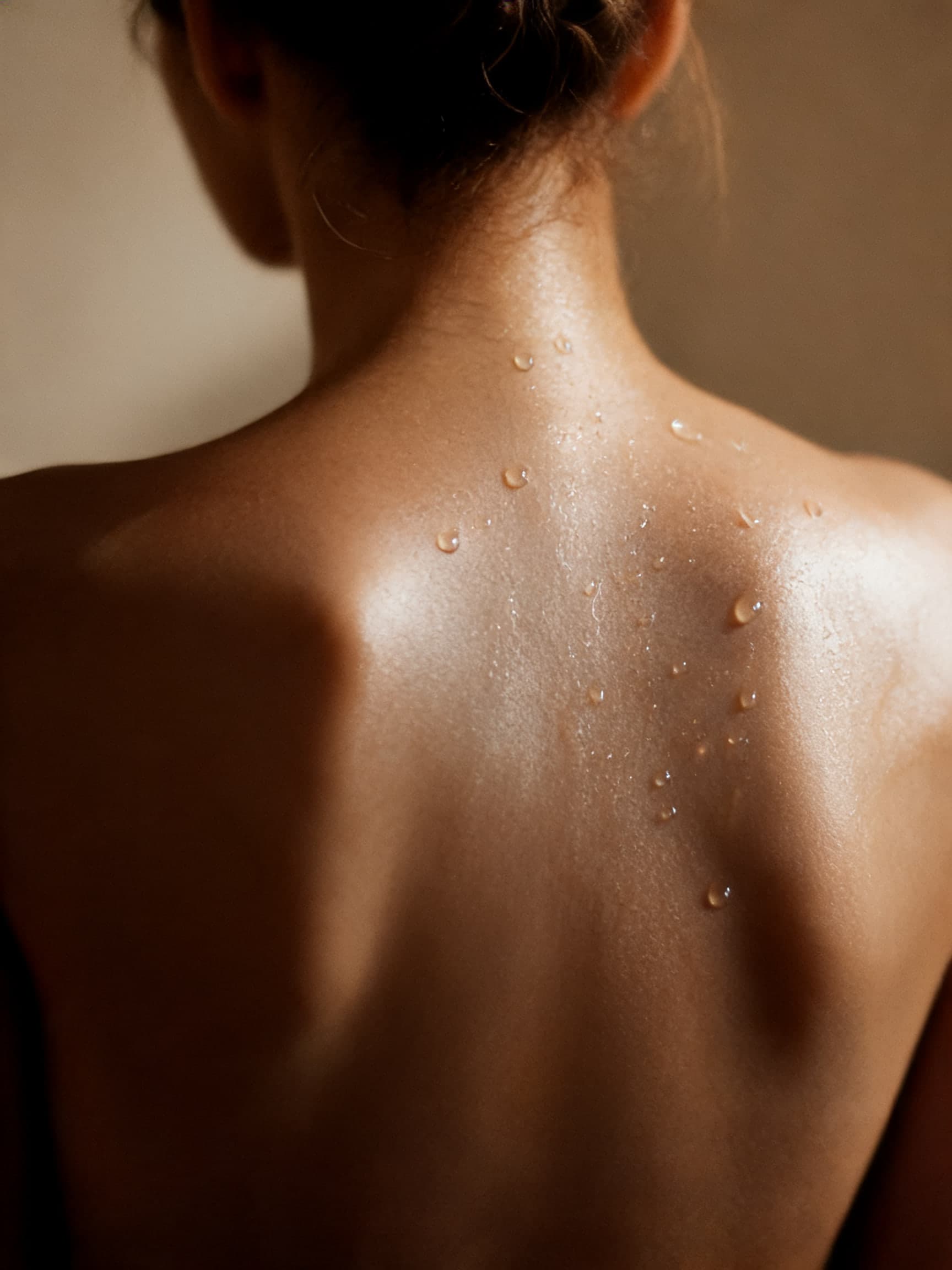 Water droplets resting on luminous skin